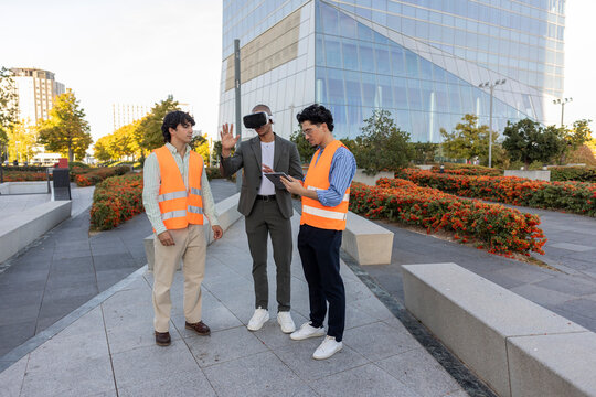 Businessmen using technology in urban setting