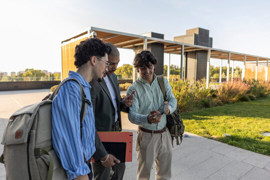 Businessmen interacting outdoors in urban setting