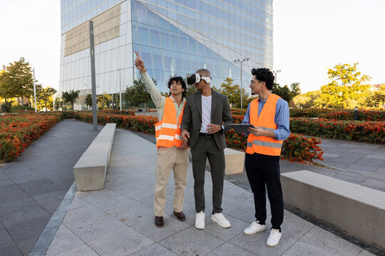 Engineers and businessmen using VR in urban planning