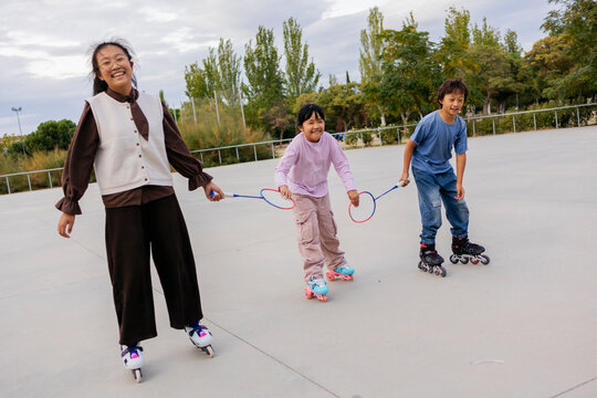 Asiatic children enjoying roller skating together