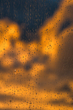 Abstract raindrops on glass during sunset
