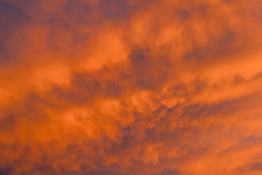 Abstract sunset sky with orange and purple clouds