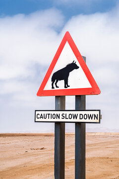 Caution sign with hyena graphic in Namibian desert