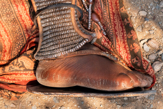 Himba foot adorned in traditional jewelry