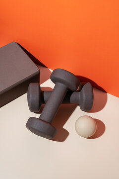 Dumbbells and yoga block for home workout setup