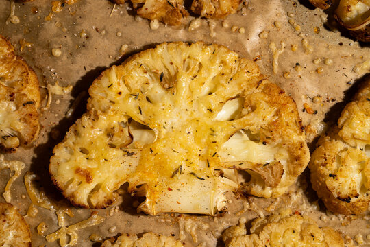 Roasted cauliflower steaks on parchment paper