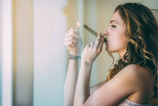 Woman enjoying a moment with a glass blunt