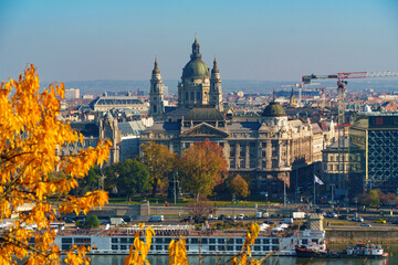 Naklejka premium Budapest cityscape, panoramic view of city and Danube River, St. Stephen's Basilica and beautiful architecture in autumn season, trees and yellow leaves
