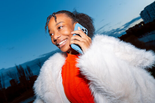 Gen Z girl enjoying a phone call in authentic portrait