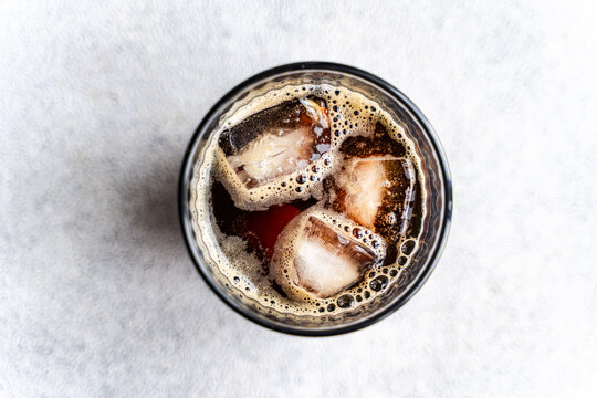 Refreshing glass of iced cola viewed from above