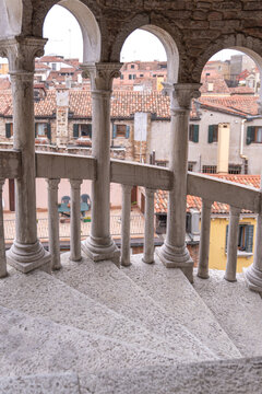 Spiral stairway of scala Bovolo overlooking Venice rooftops