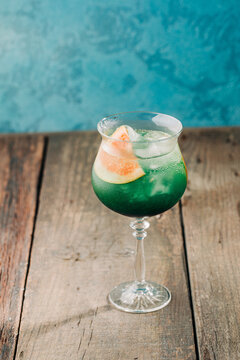 Refreshing cocktail with citrus garnish in a bar setting