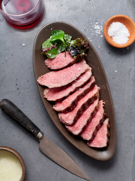 Sliced steak on oval plate, ideal for keto diet enthusiasts