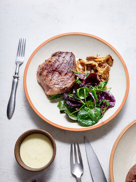 Keto beef steak with greens and sauce on plate