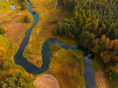 Winding Radunia river flowing through autumn landscape in Kashubia, Poland