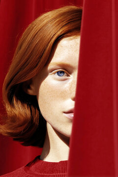 Portrait of a woman with striking red hair and blue eyes