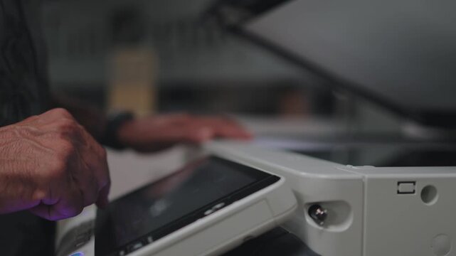 Office worker using a digital photocopy machine