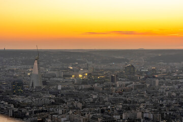 Naklejka premium Paris, France - 03 03 2026: Montparnasse Tower: View of The Triangle Tower building and skyscrapers near Porte de Versailles at sunset from the rooftop
