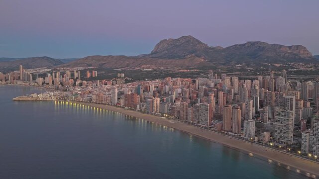 Aerial view of benidorm skyline along the mediterranean coast at dusk