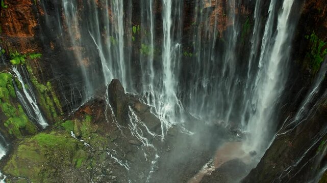Aerial panorama of Tumpak Sewu waterfall system on Mount Semeru slopes, Java, Indonesia