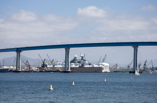 Part of the Coronado Bay Bridge and Bae systems and Nassco Builder on the background.