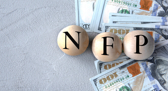 NFP - acronym on wooden balls on the background of banknotes