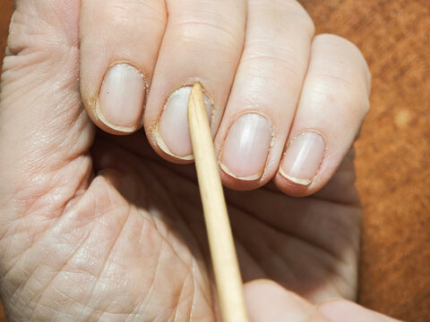 Home manicure process showing natural unpolished nails and aging hands with nail care routine