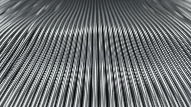Abstract metallic waves with a rippled surface texture creating a futuristic and industrial background effect