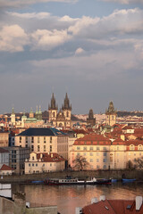 Fototapeta premium Prague skyline with Týn Church and Vltava River under soft evening light