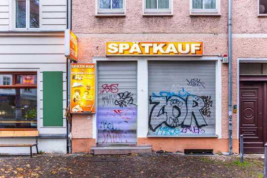 damaged food store sp&auml;tkauf - late bargain - in Berlin with grafitty at the shutter. Looking damaged and dirty in Berlin
