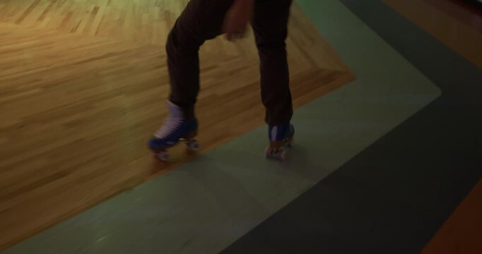 Cinematic steady cam shot following professional, young, male skater across disco floor