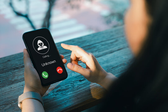 Cybersecurity and scam awareness concept. Woman receiving unknown caller on smartphone screen, highlighting phone fraud, spam risk, identity theft, and the importance of digital privacy protection.