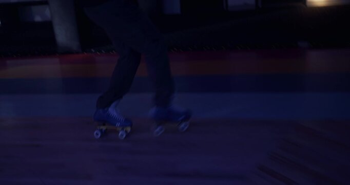 Smooth steady cam shot with professional skater doing impressive moves across disco floor