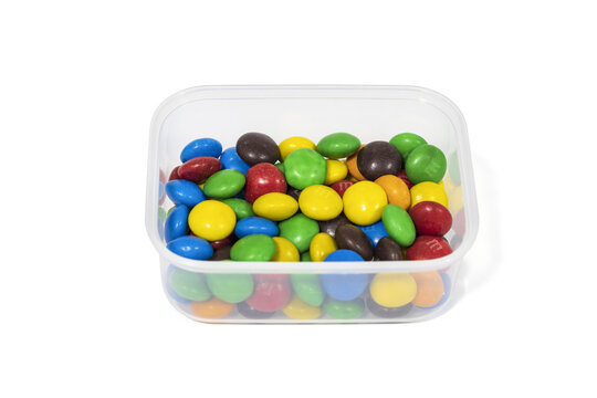 Colorful chocolate candies in a bowl isolated on white background