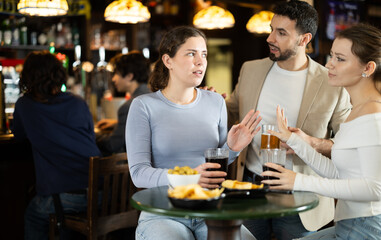 Woman is annoyed by a flirting man. Man meets a young woman in a bar and gets rejected