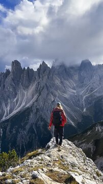 Man Walking on Mountain Ridge &ndash; Tre Cime Landscape
Man walking along exposed mountain ridge with Tre Cime peaks rising behind.