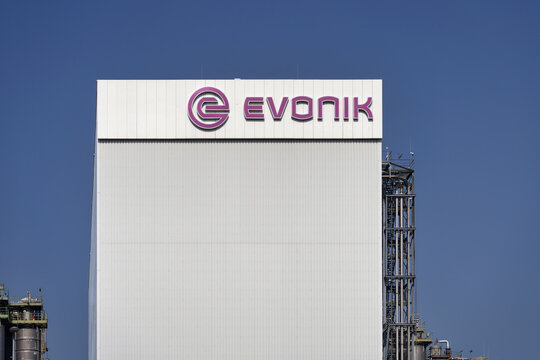 Wesseling Germany March 09 2026: Modern industrial facility of Evonik Industries in Wesseling, featuring the corporate logo on a white facade under a clear blue sky