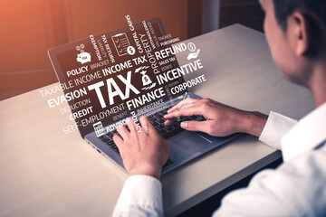 A person works on a laptop in a modern office environment, engaging with various tax concepts such as tax incentives, refunds, and financial planning elements. Tessel