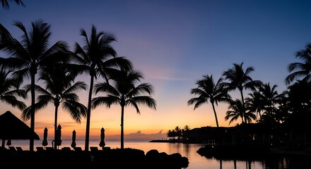 Obraz premium Tropical Sunset with Palm Trees Silhouetted Against a Vibrant Sky.