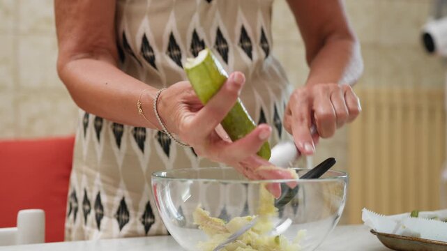 A woman prepares typical Sicilian food with homemade stuffed courgettes