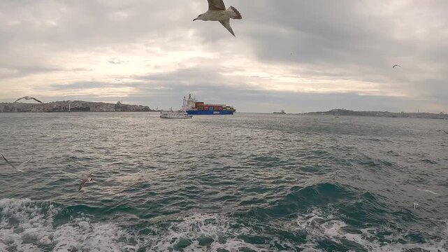 Cargo Ship Passing Through Bosphorus Strait. Bulk Carrier Ship, Bosphorus Strait, Turkey. Sea freight transportation concept. Transport logistics.