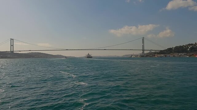 Sea freight transportation concept. Super Tanker Ship Cruising Along Bosporus. Tanker ship pass through the bosporus with bosphorus bridge in istanbul turkey. Istanbul strait. 