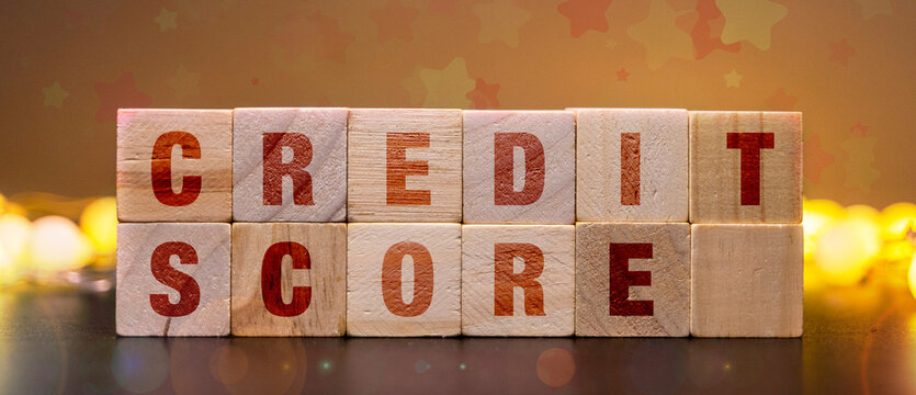 Credit Score Improvement Concept with Wooden Blocks and Warm Bokeh Background