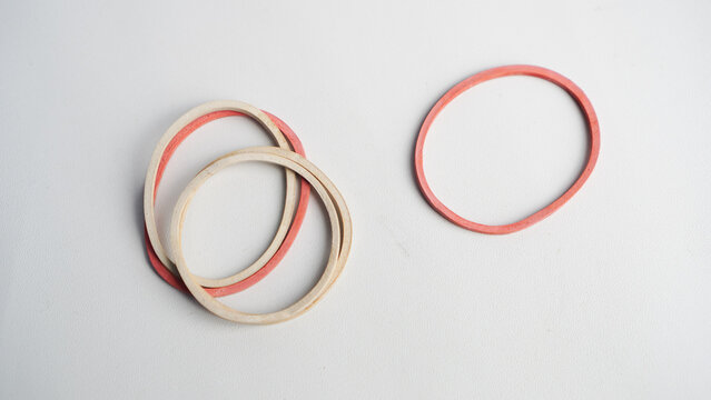 A bunch of rubber bands are laying on a white surface