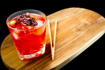 Refreshing Red Hibiscus Mocktail with Ice Cubes and Dried Flower Garnish on Wooden Table, Healthy Antioxidant Cold Drink for Wellness and Summer Lifestyle 3 © Sergio Palacio
