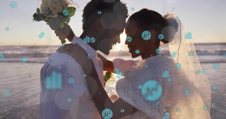 Naklejka premium Embracing bride and groom at beach sunset, wedding dress, white shirt, bouquet, tech overlay