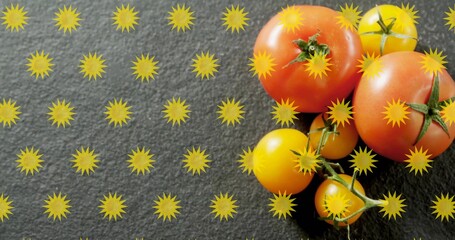 Naklejka premium Showing red tomatoes and yellow cherry tomatoes on dark slate, with stems, yellow stars, copy space