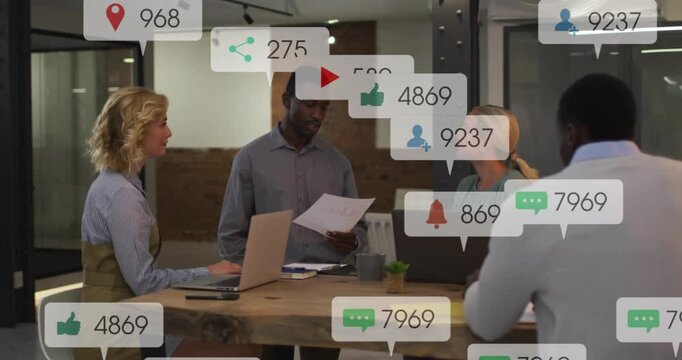 Standing man reading doc, team at table, causing social badges showing likes plays shares for media
