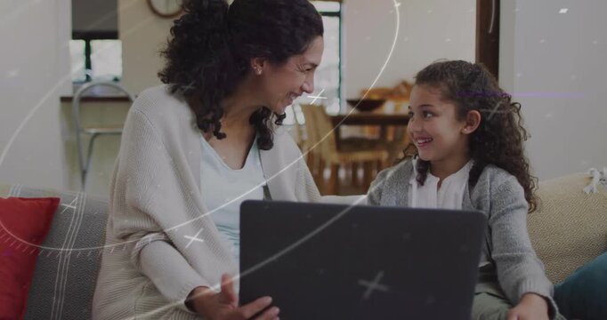 Vertical video: Laptop being held, mom and child sharing smiles and laughter, camera moving right