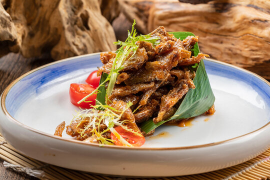 Black bean dace served on a white porcelain plate